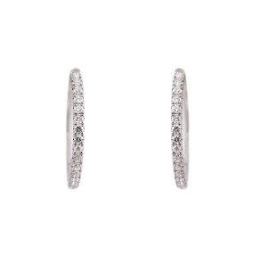 A pair of diamond circle hoop earrings in 18K white gold. Each set with round brilliant cut diamonds in a fine claw setting design on the front of the earring with a post and clip backing. Diamond Carat: 34 = 0.70ct