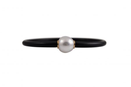Autore South sea pearl neoprene bracelet. Featuring a 12mm semi drop white South Sea pearl. The pearl has small 18K yellow gold rondelles on  either side which is attached to a black neoprene bracelet.