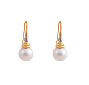 A pair of 18K yellow gold Fresh Water pearl earrings. The pearls are round in shape at 10.5 - 11mm in diameter, with an excellent skin surface and brilliant lustre. The earrings are a drop shepherd hook with pyramid style cups with a round brilliant diamond set at the top of pyramid.