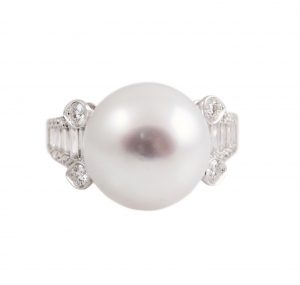 Art Deco Style South Sea Pearl and Diamond ring set in 18K white gold, featuring a 12mm round, white South Sea pearl. The ring is set with 28 round brilliant cut diamonds and 14 baguettes.