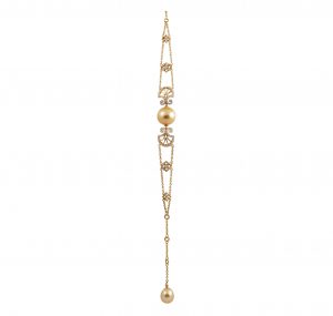 An 18K yellow gold Autore Art Nouveau Style South sea pearl and diamond bracelet. Featuring a Golden South sea 13mm button pearl in the middle with a diamond Nouveau decorative fan style on either side flowing through with two chain holding them together and another golden pearl at the end of bracelet being  approx 11mm with 105 diamonds total 0.66ct.