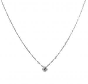 This solitaire necklace bezel set is made in 18K white gold, featuring a 0.11ct round brilliant cut diamond set into a bezel setting that slides on a 41cm trace chain. Carat: 1 = 0.11ct Colour: G Clarity: SI