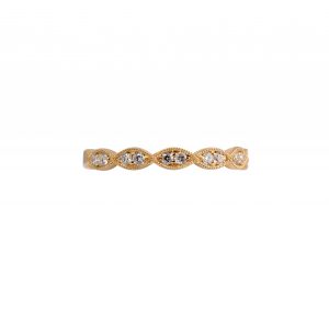 An 18K yellow gold marquise shape diamond wedding band. Made up of marquise shapes in a row, each section is bead set with two diamonds and finished off with a milgrain edge. Carat: 14 = 0.18ct Ring size: L 1/2