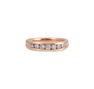 An 18K rose gold pink diamond channel set ring. The ring is channel set with a single row of 7 pink round brilliant cut diamonds. Carat: 7 = 0.41ct Ring size: L