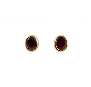 red gemstone with yellow gold studs