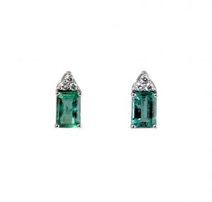 A pair of emerald gemstone studs set in 18K white gold, featuring two rectangular statement emeralds set with three diamonds in a claw setting. CARAT: Emerald 2 = 1.32ct Diamonds 6 = 0.08ct