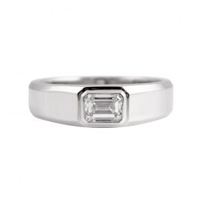 Emerald cut ring in platinum 950, featuring a 0.74ct rectangular Emerald cut diamond set into a bezel setting. CAR