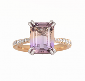 Ametrine and diamond two tone dress ring. Set with a 3.88ct step cut Ametrine claw set with diamonds half way around the band set in 18K yellow and white gold. Gemstone Carat: Ametrine = 3.88ct Diamond Carat: 26 = 0.21ct RING SIZE: L1/2