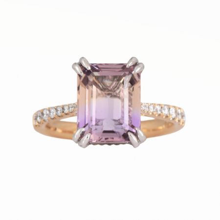 Ametrine and diamond two tone dress ring. Set with a 3.88ct step cut Ametrine claw set with diamonds half way around the band set in 18K yellow and white gold. Gemstone Carat: Ametrine = 3.88ct Diamond Carat: 26 = 0.21ct RING SIZE: L1/2